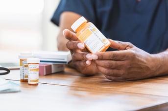 GettyImages-1268333171-Hands_Pill_Bottle_Closeup-RET-3